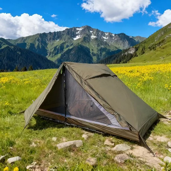 Single Person Ultralight Backpacking Tent_6 An ultralight backpacking tent pitched on a mountain ridge during a solo hike.