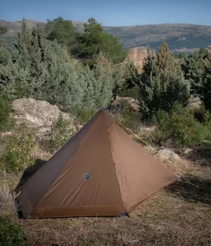 The solo camping tent standing stable during a windy nature hike.