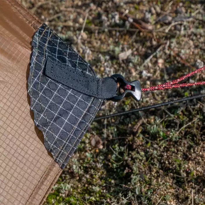 A hiker packing the 1 person FLAME'S CREED tent into a compact bag.