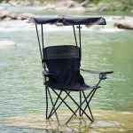 Camping chair with sun canopy used by river for outdoor relaxation