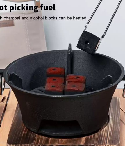 Heat-resistant handle on a portable kettle BBQ for safe temperature control while cooking outdoors.