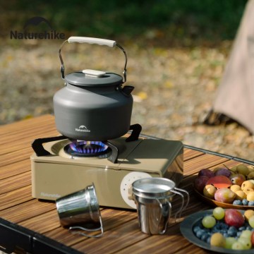 Camping kettle boiling on gas stove UK outdoor cooking gear