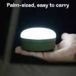 MOSLIGHTING LED light with integrated hanging hook for hands-free use.