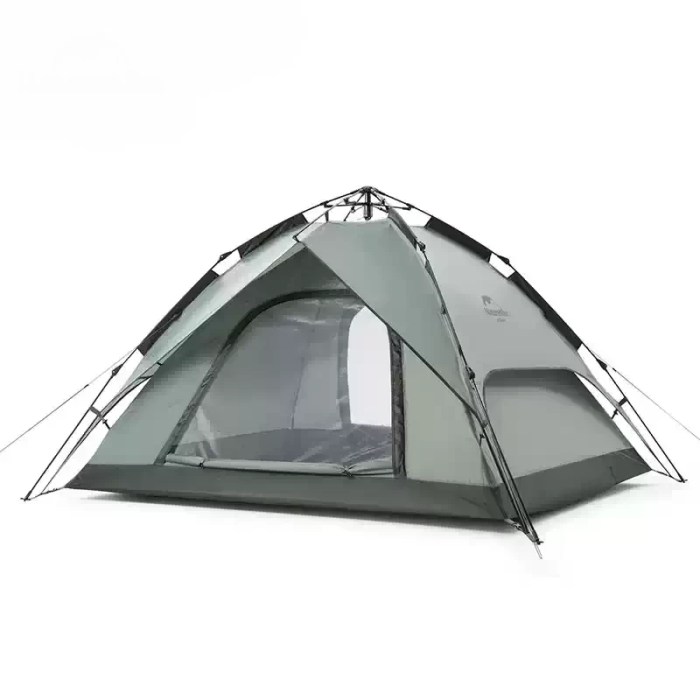 Green Naturehike automatic tent fully pitched on a lush UK campsite with guy lines secured.