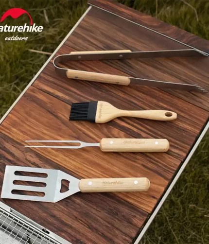 An evening BBQ setup in the Lake District featuring the Naturehike tool set and walnut camping table.