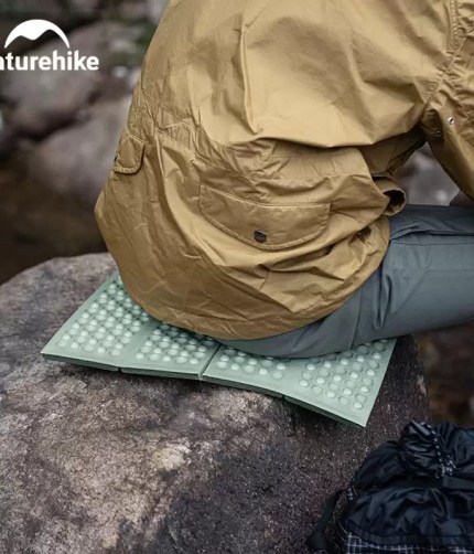 Portable folding sit mat providing a dry seat during UK hikes.