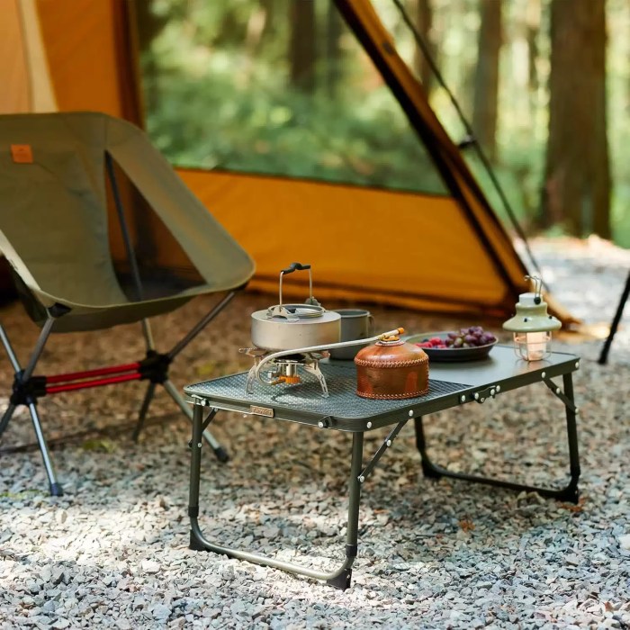 NATUREHIKE FOLDING CAMPING TABLE_3 Naturehike folding table being used during a wilderness camping trip.