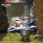 Naturehike mini stove boiling water in a titanium pot during a wild camp in the Scottish Highlands.
