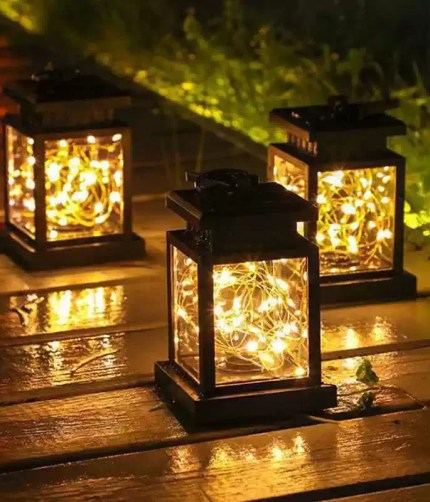Decorative solar LED outdoor lanterns featuring an integrated high-efficiency solar panel for UK garden and campsite lighting.