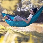 Ultralight 2 person camping hammock used outdoors by two people by the water