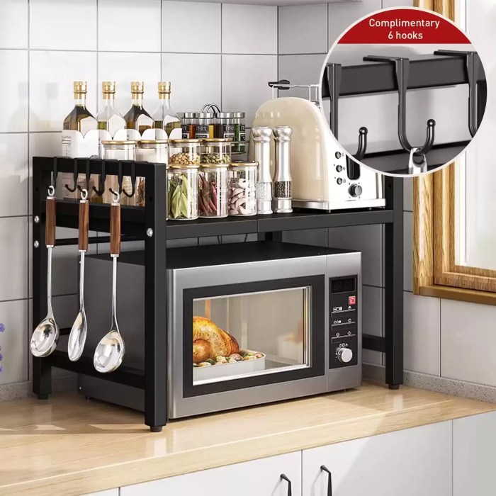 EXPANDABLE MICROWAVE SHELF ORGANIZER (42-64CM)_6 Two-tier expandable microwave oven rack with complimentary hanging hooks organizing kitchen supplies and spices.