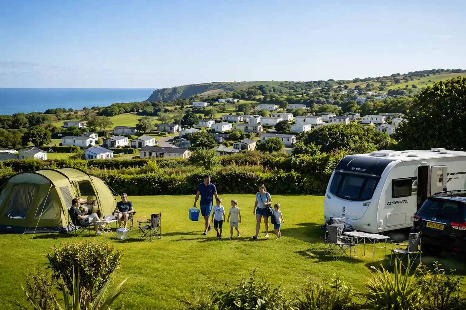 amily camping at Tenby Pembrokeshire with tent and caravan on coastal campsite UK outdoor holiday