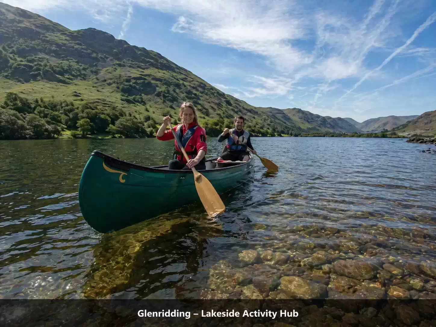 Couple canoeing on Ullswater at Glenridding with clear water and scenic Lake District mountains