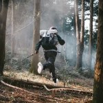 Hiker using Helium 30+5L backpack on rugged mountain terrain