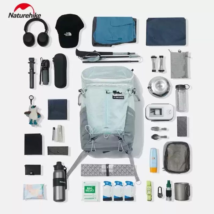 FJK Camping Gear Naturehike Helium 20L backpack storage capacity demonstration showing hiking essentials, electronics, and camping gear organized around the bag.