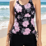Pink floral printed tankini swimsuit with black high waist swim shorts.