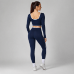 Women’s navy long-sleeve crop top and high-waisted leggings set shown from the back