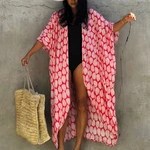 Women's coral printed beach kimono with flowing sleeves for tropical holidays and resort wear.