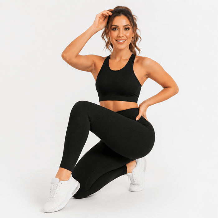 Black High-Waisted Yoga Leggings Woman wearing black high-waisted yoga leggings in a seated studio pose
