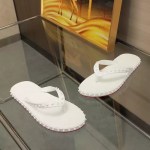 Clean white studded rubber flip flops featuring spiked straps and textured soles for casual summer wear.