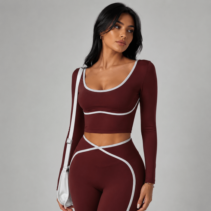 Close-up of women’s burgundy activewear set with contrast trim and crossover waistband