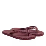 Maroon studded rubber flip flops featuring spiked straps and textured soles for casual everyday wear.