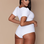 Side view of women's white plus size monokini swimsuit with flattering silhouette and stretch fabric.