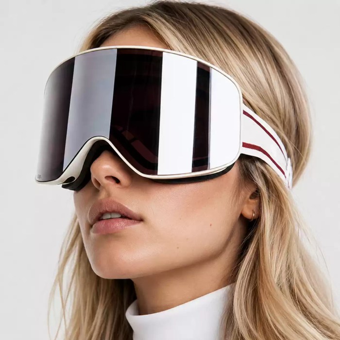 Woman wearing oversized silver mirrored ski goggles with a wide panoramic lens