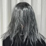 Back view of Halloween witch mask with long grey hair