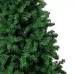 Dense green branches of an artificial Christmas tree on white background.
