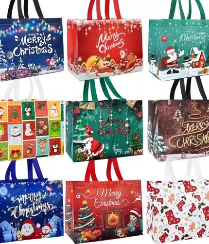 Assorted Christmas gift bags with Santa, snowman and holiday designs.