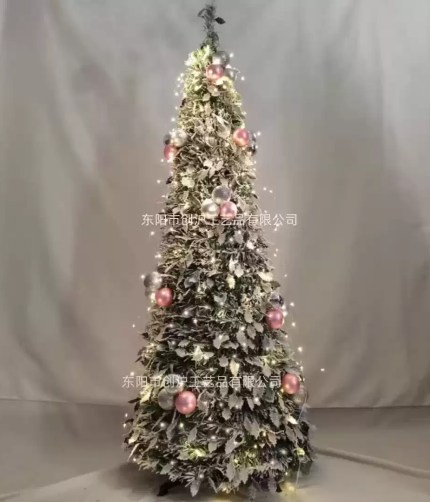 Flocked Christmas tree with warm lights and pink silver baubles.