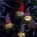 Hanging Christmas gnome decorations displayed on a festive tree