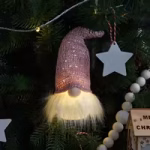 Hanging Christmas gnome decoration with glowing beard and star ornament